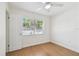 Bright bedroom features wood floors and natural light from the window at 930 29Th Nw St, Winter Haven, FL 33881