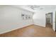 Bright bedroom with wood floors, ceiling fan, and a view to the bathroom at 930 29Th Nw St, Winter Haven, FL 33881