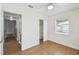 Bright bedroom features wood floors, closet, and natural light from the window at 930 29Th Nw St, Winter Haven, FL 33881