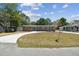 Charming brick home featuring a circular driveway, blue shutters, and a well-manicured lawn under a sunny sky at 930 29Th Nw St, Winter Haven, FL 33881