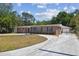 Charming brick home with blue shutters, lush landscaping, and a spacious driveway at 930 29Th Nw St, Winter Haven, FL 33881