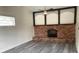 Cozy living room featuring a decorative brick fireplace and modern ceiling fan at 930 29Th Nw St, Winter Haven, FL 33881