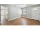 Bright living room featuring wood floors, large windows, and neutral paint at 930 29Th Nw St, Winter Haven, FL 33881
