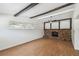 Bright living room featuring wood floors, a brick fireplace, and beamed ceiling at 930 29Th Nw St, Winter Haven, FL 33881