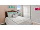 Cozy bedroom with a comfortable bed, decorative pillows, and a well-lit ambiance at 3317 Armstrong Ave, Clermont, FL 34714