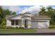 Charming single-story home with a two-car garage, manicured lawn, and attractive stone accents at 3317 Armstrong Ave, Clermont, FL 34714