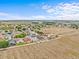 Wide aerial view of a large neighborhood, showing many rooftops, yards, and a blue sky at 438 Cotswold Cir, Davenport, FL 33837