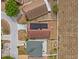 Aerial view of a brick home with a solar panel roof and a paved driveway at 438 Cotswold Cir, Davenport, FL 33837