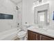 Bathroom features modern fixtures, tiled walls, and a vanity at 438 Cotswold Cir, Davenport, FL 33837