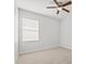 Bedroom featuring neutral carpet, a ceiling fan, and a window at 438 Cotswold Cir, Davenport, FL 33837
