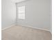 Simple bedroom with neutral carpeting, a window with blinds, and plenty of natural light at 438 Cotswold Cir, Davenport, FL 33837
