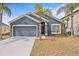 Charming single-Gathering home with a well-maintained lawn and an attached two-car garage at 438 Cotswold Cir, Davenport, FL 33837