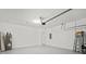 Spacious and clean garage featuring a water heater, ladder and door to the house at 438 Cotswold Cir, Davenport, FL 33837