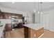 Modern kitchen featuring a center island, stainless steel appliances, and stylish pendant lighting at 438 Cotswold Cir, Davenport, FL 33837