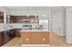 Modern kitchen with brown cabinetry, stainless steel appliances and a large island with a wooden base at 438 Cotswold Cir, Davenport, FL 33837