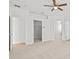 Bright main bedroom with a ceiling fan, large windows, and multiple closets for ample storage at 438 Cotswold Cir, Davenport, FL 33837