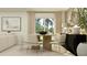 Elegant dining area with a round wooden table, neutral chairs, and modern decor at 1311 Blue Ash Ln, Deland, FL 32720