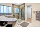 Relaxing bathroom features a soaking tub, tiled shower with glass door, and natural light at 16755 Sunrise Vista Dr, Clermont, FL 34714