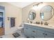 This bathroom offers double sinks, a modern vanity, and tiled floors at 16755 Sunrise Vista Dr, Clermont, FL 34714