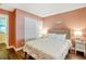 Charming bedroom with neutral tones, plush bedding, and a closet providing ample storage space at 16755 Sunrise Vista Dr, Clermont, FL 34714