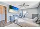 Spacious bedroom with a fan, a large TV, and soft carpet at 16755 Sunrise Vista Dr, Clermont, FL 34714