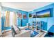 Bright bedroom with two TVs, modern decor, and cozy seating at 16755 Sunrise Vista Dr, Clermont, FL 34714