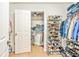 Organized walk-in closet featuring ample storage space for shoes and clothing at 16755 Sunrise Vista Dr, Clermont, FL 34714