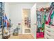 Organized walk-in closet featuring ample storage space for shoes and clothing at 16755 Sunrise Vista Dr, Clermont, FL 34714