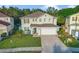 Two story home with a two car garage, a well manicured lawn, and neutral colored paint at 16755 Sunrise Vista Dr, Clermont, FL 34714