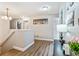 Bright hallway with dark wood flooring, doors leading into other rooms, and wall decor at 16755 Sunrise Vista Dr, Clermont, FL 34714