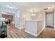 Bright hallway with dark wood flooring, doors leading into other rooms, and railing at 16755 Sunrise Vista Dr, Clermont, FL 34714