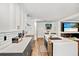 Kitchen with island, stainless steel appliances, white countertops, and stylish tile backsplash at 16755 Sunrise Vista Dr, Clermont, FL 34714