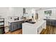 Bright kitchen with white upper and black lower cabinets, white countertop, and stainless steel appliances at 16755 Sunrise Vista Dr, Clermont, FL 34714