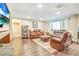 Spacious living room area with couches, wood floors, art, and direct access to the bathroom at 16755 Sunrise Vista Dr, Clermont, FL 34714
