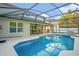 Lovely backyard pool area with patio table and chairs, grill, and spa at 16755 Sunrise Vista Dr, Clermont, FL 34714