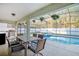 Covered patio area with a dining table set overlooking a refreshing screened pool at 16755 Sunrise Vista Dr, Clermont, FL 34714