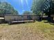 Large backyard featuring deck, lawn, and wooden fence, perfect for outdoor enjoyment at 1831 Quail Trl, Lakeland, FL 33810