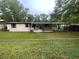 Backyard view of home featuring a covered carport and chain link fence at 1831 Quail Trl, Lakeland, FL 33810