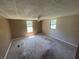 Spacious bedroom featuring neutral walls, carpet flooring, and dual windows for ample natural light at 1831 Quail Trl, Lakeland, FL 33810