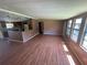 Open living space features wood flooring and a view to the kitchen area at 1831 Quail Trl, Lakeland, FL 33810