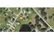Aerial view showing the location of the property in relationship to the neighborhood and nearby lake at 25322 Columbia Cir, Lake Wales, FL 33898