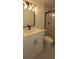 Bathroom with white vanity, black hardware, decorative lighting and a glass enclosed shower at 25322 Columbia Cir, Lake Wales, FL 33898