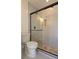Bathroom featuring a glass-enclosed shower with decorative tile and a modern toilet at 25322 Columbia Cir, Lake Wales, FL 33898