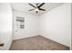 Bright bedroom features neutral carpet, ceiling fan, and window at 2846 Sera Bella Way, Kissimmee, FL 34744