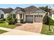 Charming single-story home featuring a two-car garage, brick driveway, and well-maintained landscaping at 2846 Sera Bella Way, Kissimmee, FL 34744