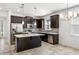 Modern kitchen features dark cabinets, stainless steel appliances, quartz countertops, and a center island at 2846 Sera Bella Way, Kissimmee, FL 34744