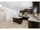 Stylish kitchen with dark wood cabinetry, stainless steel appliances, and a center island at 2846 Sera Bella Way, Kissimmee, FL 34744