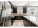 Close-up of a modern kitchen with stainless steel appliances, dark cabinets, and light countertops at 2846 Sera Bella Way, Kissimmee, FL 34744