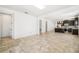 Spacious living room with neutral tile flooring and an open layout to the kitchen at 2846 Sera Bella Way, Kissimmee, FL 34744