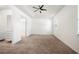 Spacious main bedroom featuring plush carpeting, tray ceiling, fan, and a walk-in closet at 2846 Sera Bella Way, Kissimmee, FL 34744
